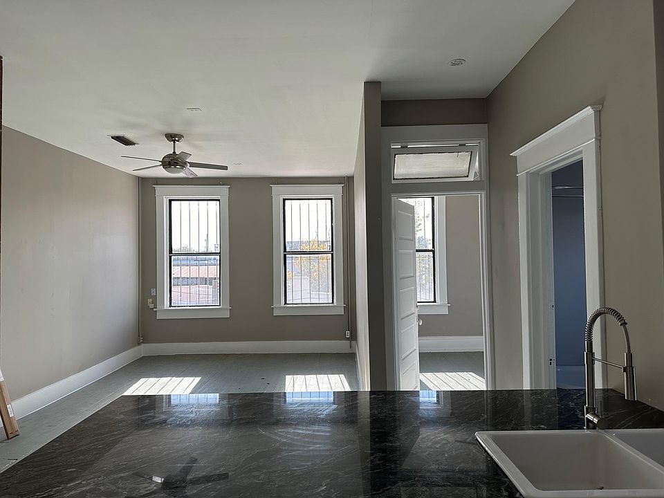 view over kitchen peninsula to living and bedroom 1 entrance