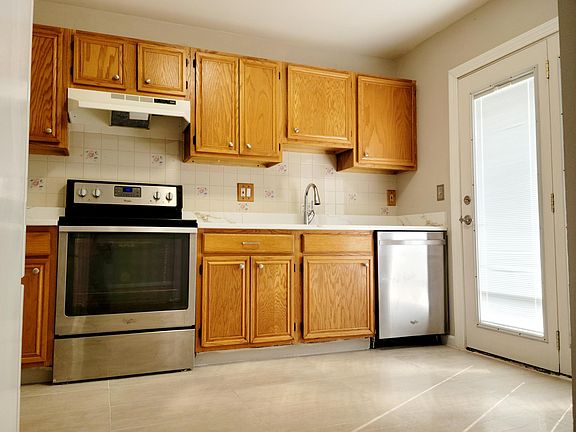 Kitchen with tile floor and quartz Countertops.