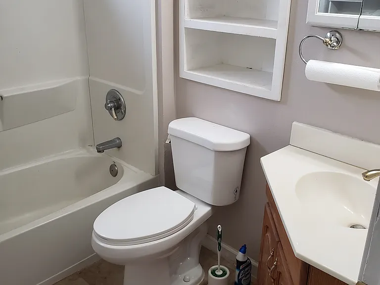 Bath with storage for Towles and two med cabinets. Heater in ceiling.