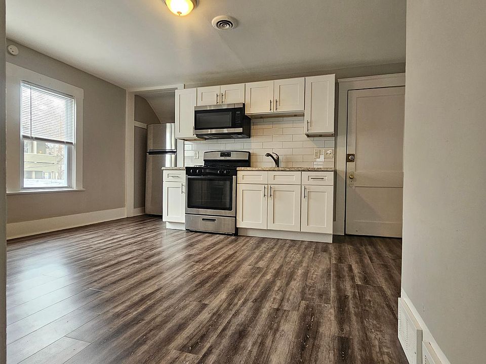 massive kitchen with stainless range, microwave and refrigerator.