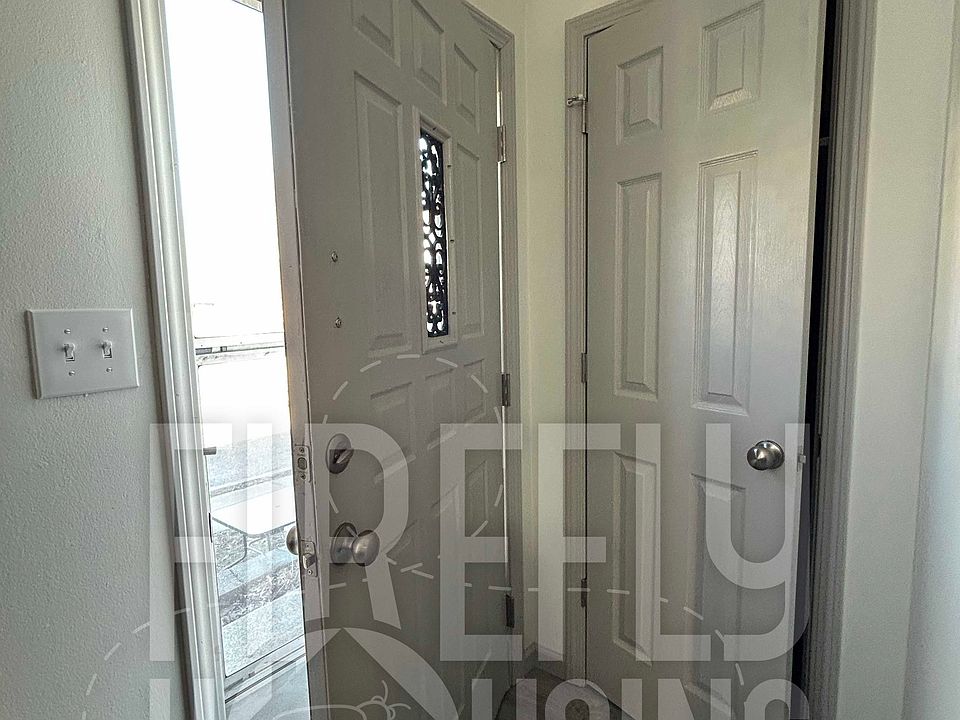 Front Entry with Storm Door, includes Coat Closet inside.