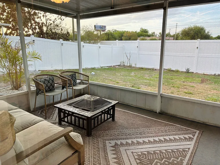 From the guest bedroom, you can access the large lanai and fully fenced in yard.