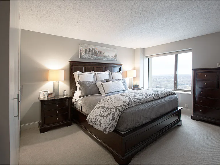 Spacious bedroom with gorgeous view of the Hennepin Bridge, Grain Belt beer sign, and Mississippi River