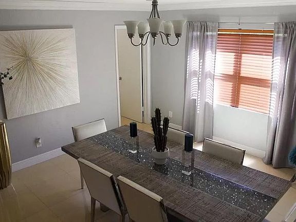 Large dining room next to kitchen and master bedroom with a back door to backyard patio. Enjoy the natural sunlight courtesy of the two large windows