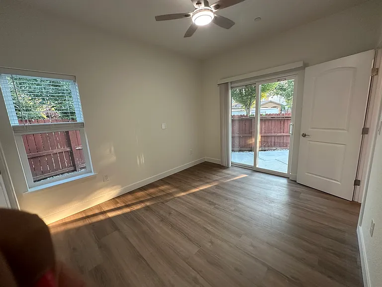 Ceiling fan and slide door to a sitting area on the back of the house