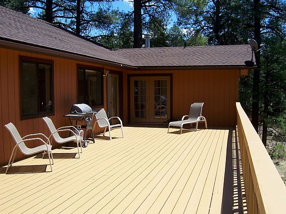 Extensive deck with bbq and chairs.