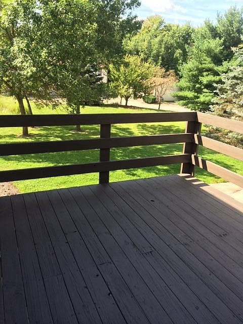 Deck overlooks park like setting