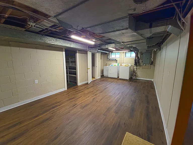 basement laundry area, lots of space for storage and a pantry fully shelved.