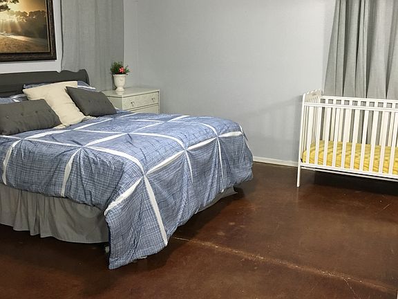 Rustic stained concrete bedroom floors