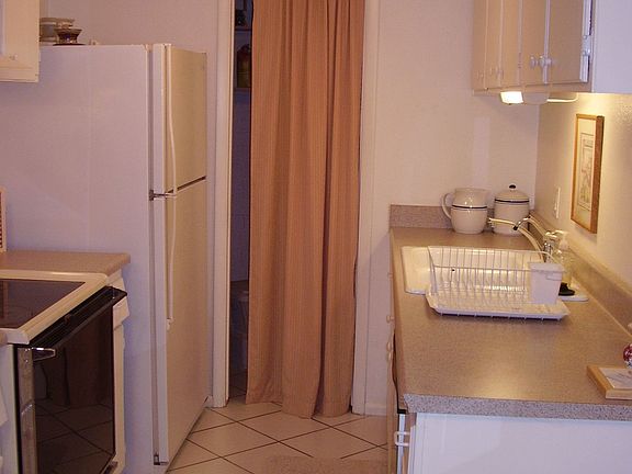 KITCHEN WITH A PANTRY FOR EXTRA STORAGE.