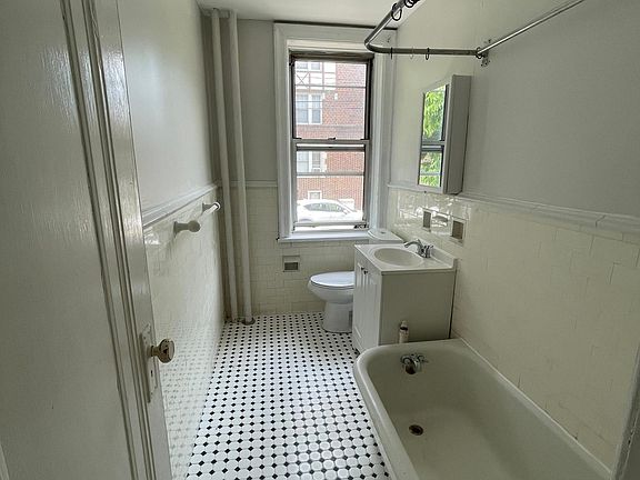 Bathroom with new floor, vanity, medicine cabinet and toilet