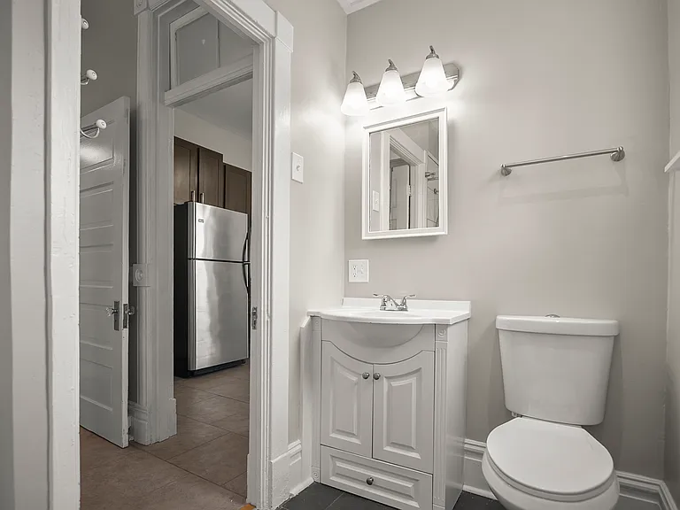 Doorway leading from the kitchen to the bathroom on the right. Bedroom access to the left and acess to the stairwell directly across from the bathroom