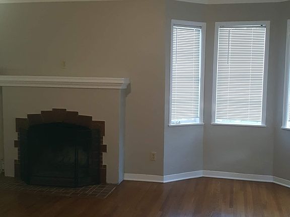 Fireplace in the front living room. Beautiful 5 window nook for morning breakfast or cozy spot to read a book.