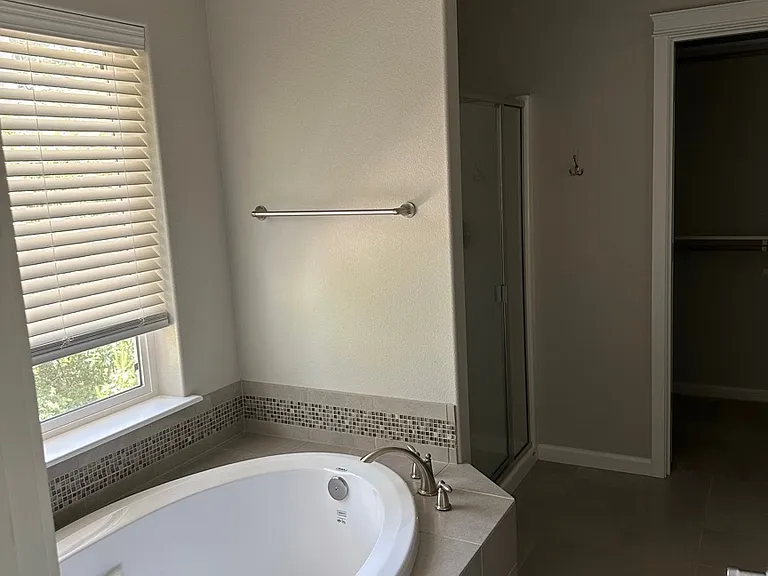 Walk-in closet in the back of the bathroom