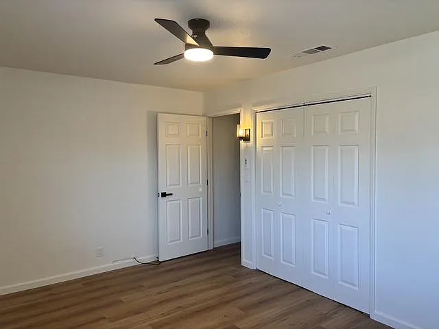 One view of the Master Bedroom, entirely renovated with all new flooring, paint, window covering, doors, spacious closet and light features.