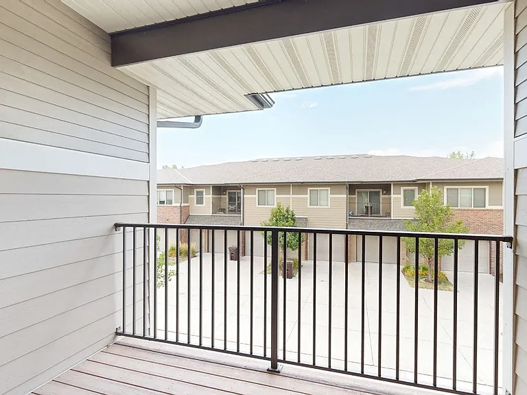 Step outside and take in the fresh air from your own private balcony, offering a quiet retreat just beyond your door.