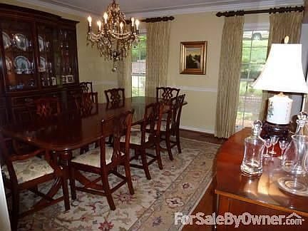 Formal Dining Room
						:
						with chair rail, crown molding, silk window treatments and chandelier.