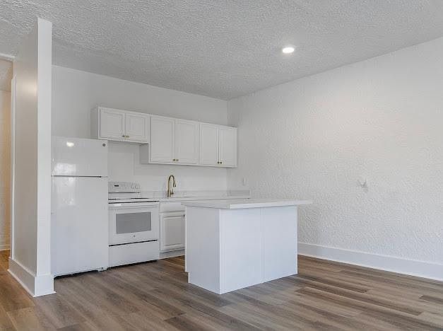 Bright, open kitchen with Quartz counters and island seating.
