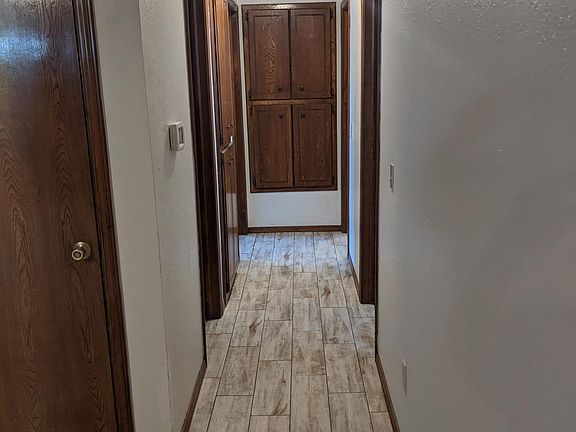 Hall showing linen closet and partially coat closet