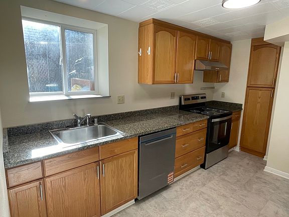 Galley style kitchen with new SS appliances and granite countertops