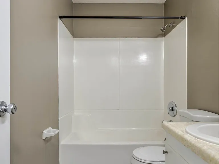 White bathtub in a bathroom.