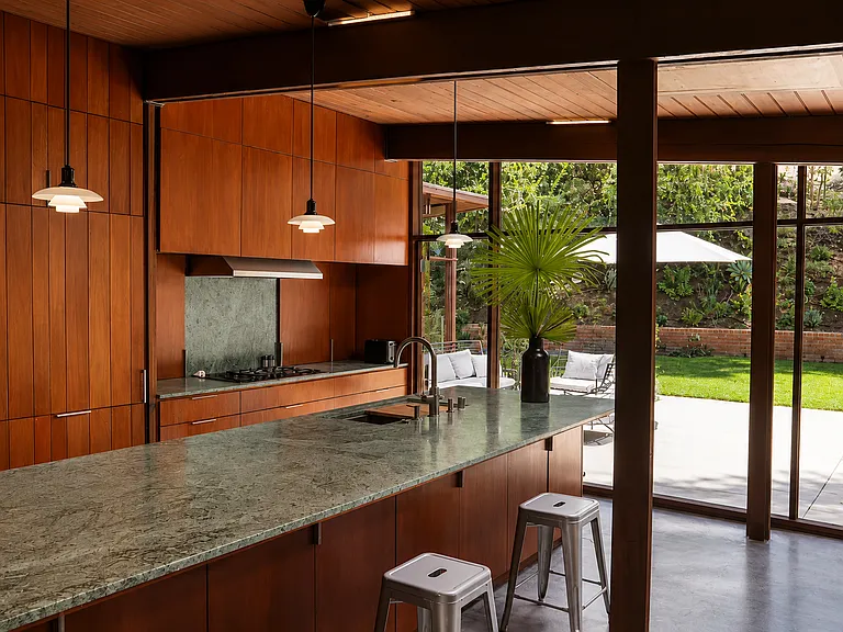 Chef's kitchen with green marble island, opening to patio and dining _ A. Quincy Jones, 1951