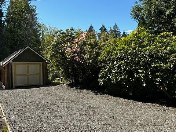 The storage shed/small garage. An extra wide driveway allows for plenty of off-street parking for guests.