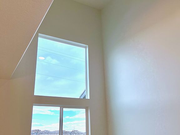 Two story living room w ceiling fan