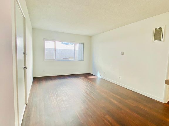 Spacious living room with large window.