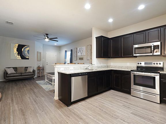 Kitchen with stainless steal refrigerator/freezer, oven range, microwave, and dishwasher included.