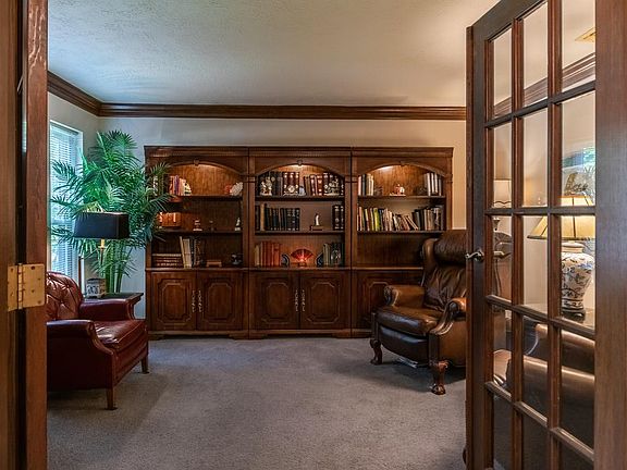 This downstairs space to the left of the front door with double French doors makes the perfect office space, windows provide a view of the lovely front yard.