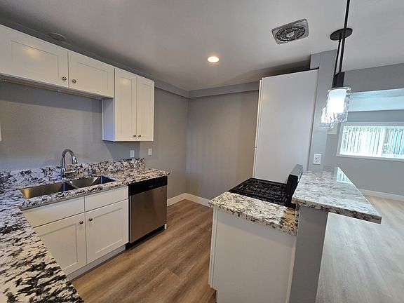 Beautiful new kitchen with dishwasher, new cabinets and custom granite counters