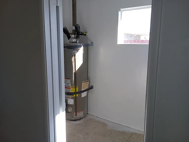 Laundry room with water heater.