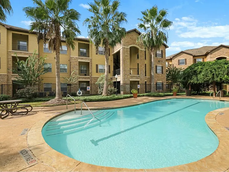 Sun sparkling swimming pool at Stonehaven Apartments in Houston, TX