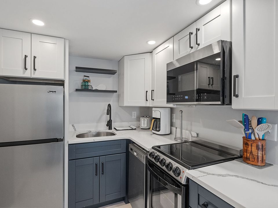 Kitchen has fridge/freezer, dishwasher, electric range, microwave, coffee maker, and toaster.