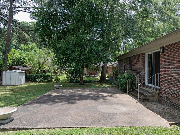 FLAT BACKYARD WITH LARGE PATIO, HUGE TREES, TOOL SHED