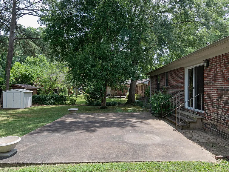 FLAT BACKYARD WITH LARGE PATIO, HUGE TREES, TOOL SHED