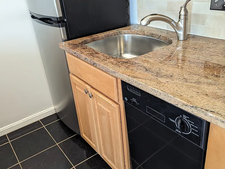 Dishwasher adjacent to sink. Previous picture as new stainless steel dishwasher was installed in Oct 2024.