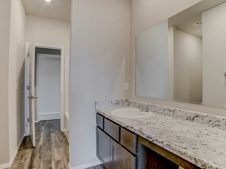 View from the full bathroom that separates the bedrooms. Straight ahead is the door to bedroom #2 and access to the living room.