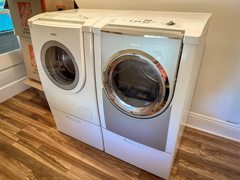private laundry room connected to bedroom with washer and dryer
