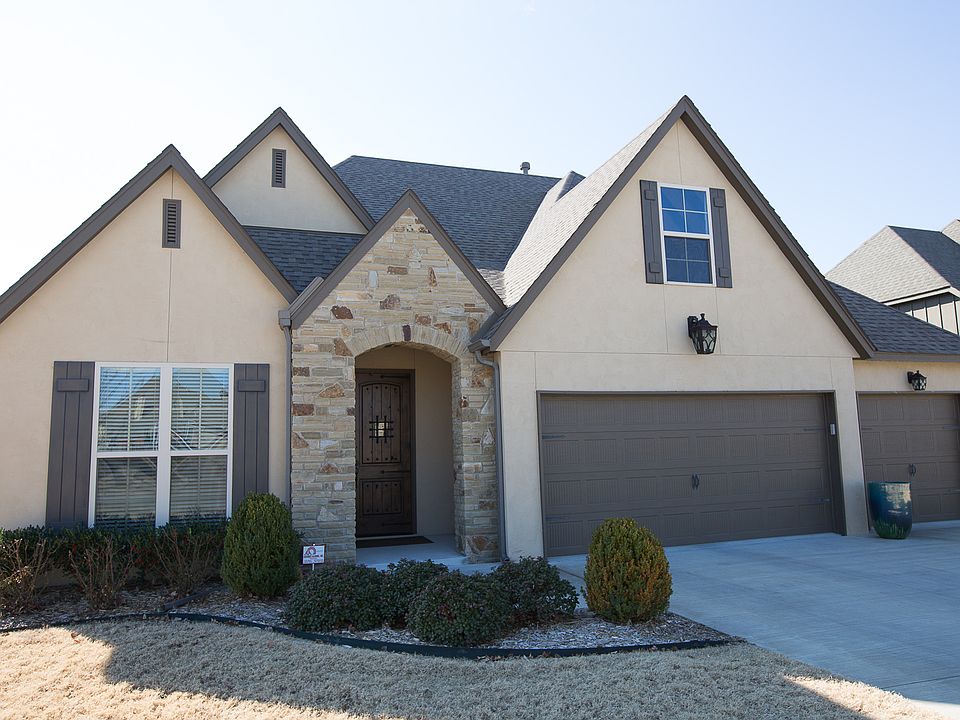 Elegant floor plan with transitional style offering views of neighborhood pond in desirable Bixby North Schools! Hand-scraped hardwoods, rustic beams and granite finishes all within an open floor plan with two Bedrooms down!