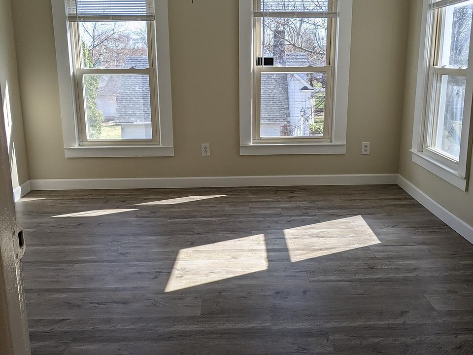 Dining room with new flooring and ceiling fan with light.