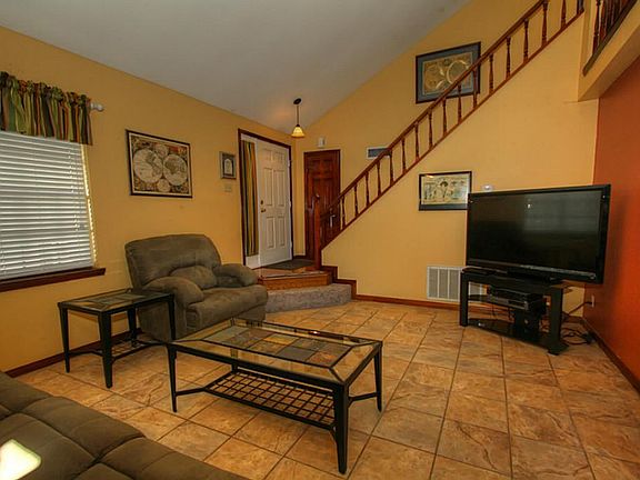 Entry with coat closet and wood floor.