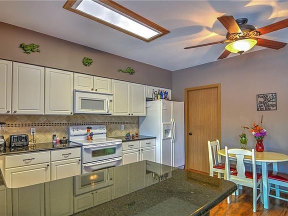 The kitchen offers a full complement of appliances, and a laundry room can be found just past the fridge.