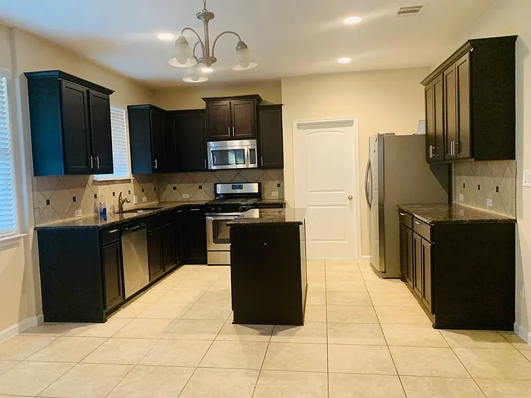 Kitchen includes gas range, microwave, dishwasher, and refrigerator