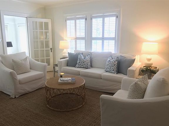 Comfy living room w/ tons of natural light and louvered shutters for privacy in the evening.