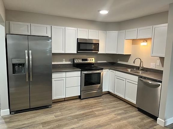 Newly remodeled kitchen with dishwasher, over the range microwave, side by side refrigerator with ice maker and Corian countertops, garbage disposal and pull down kitchen faucet.