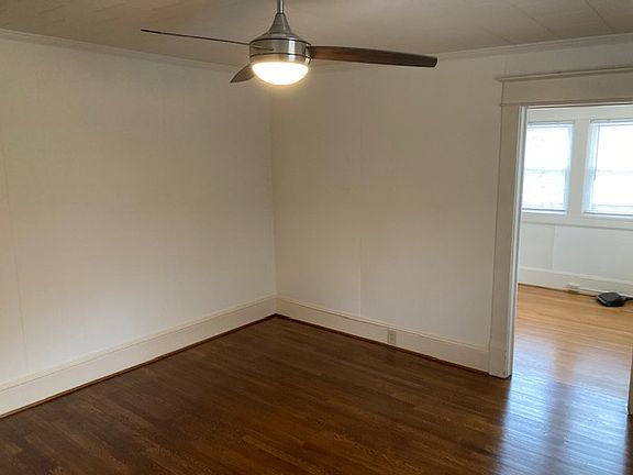 Living room with just refinished floor adjacent to kitchen 14 by 14