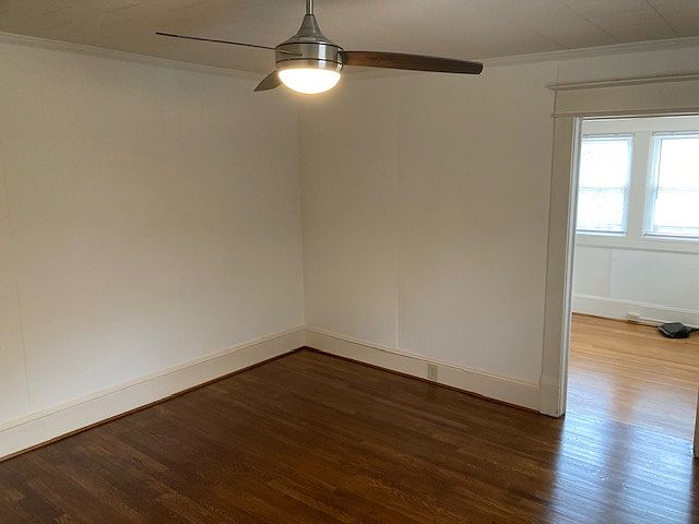 Living room with just refinished floor adjacent to kitchen 14 by 14