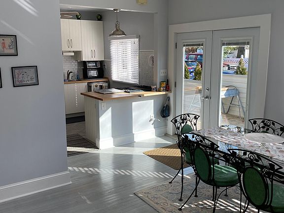 View of dining room to kitchen and out to deck.